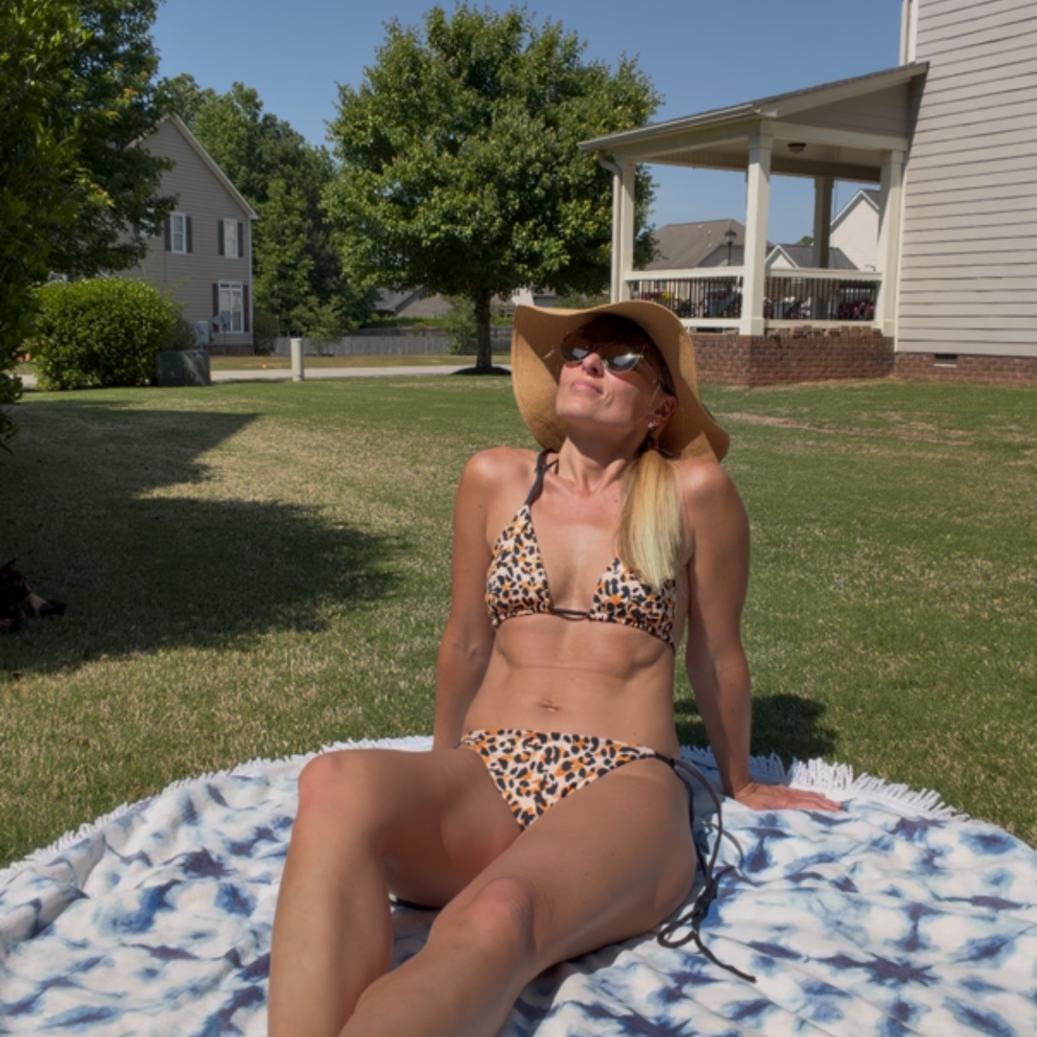 woman laying on a blanket wearing Savage cheetah string bikini by My Velveteen Habit
